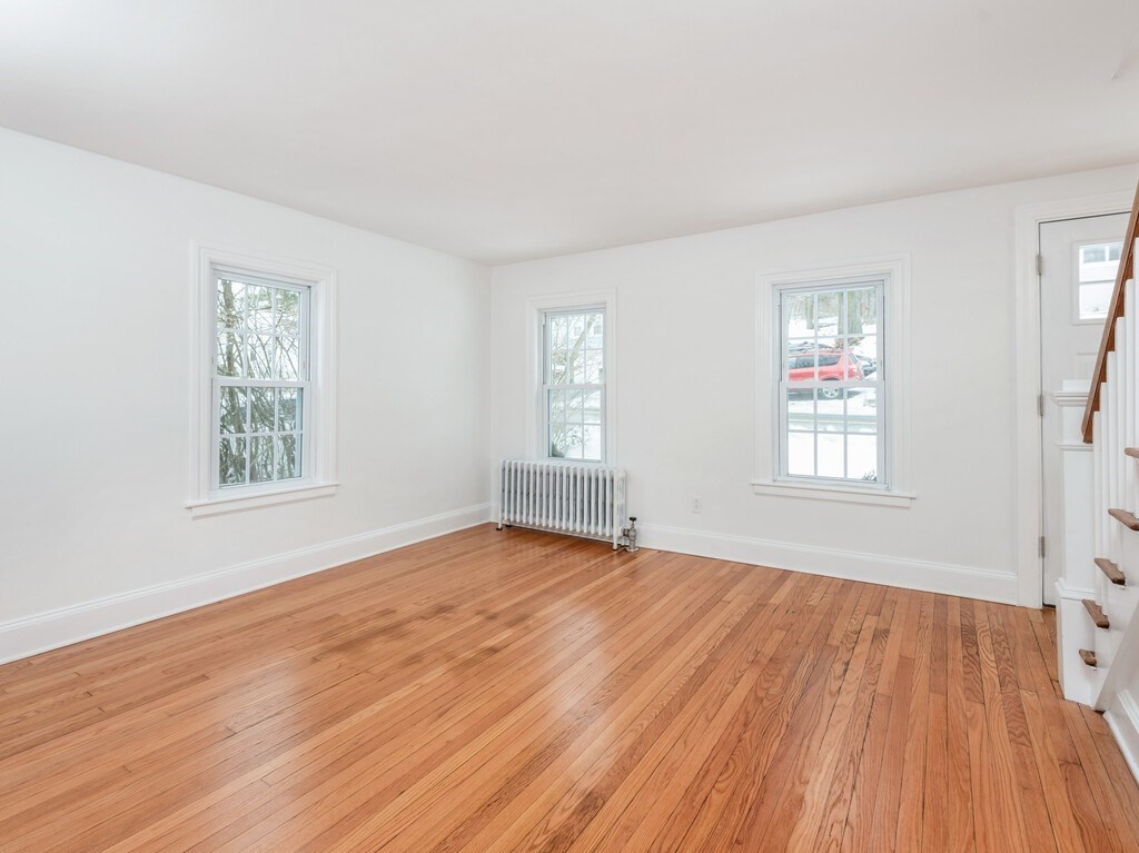 63 Upland Street Worcester, MA 01607 - Photo 15 of 36 a view of an empty room with wooden floor and a window