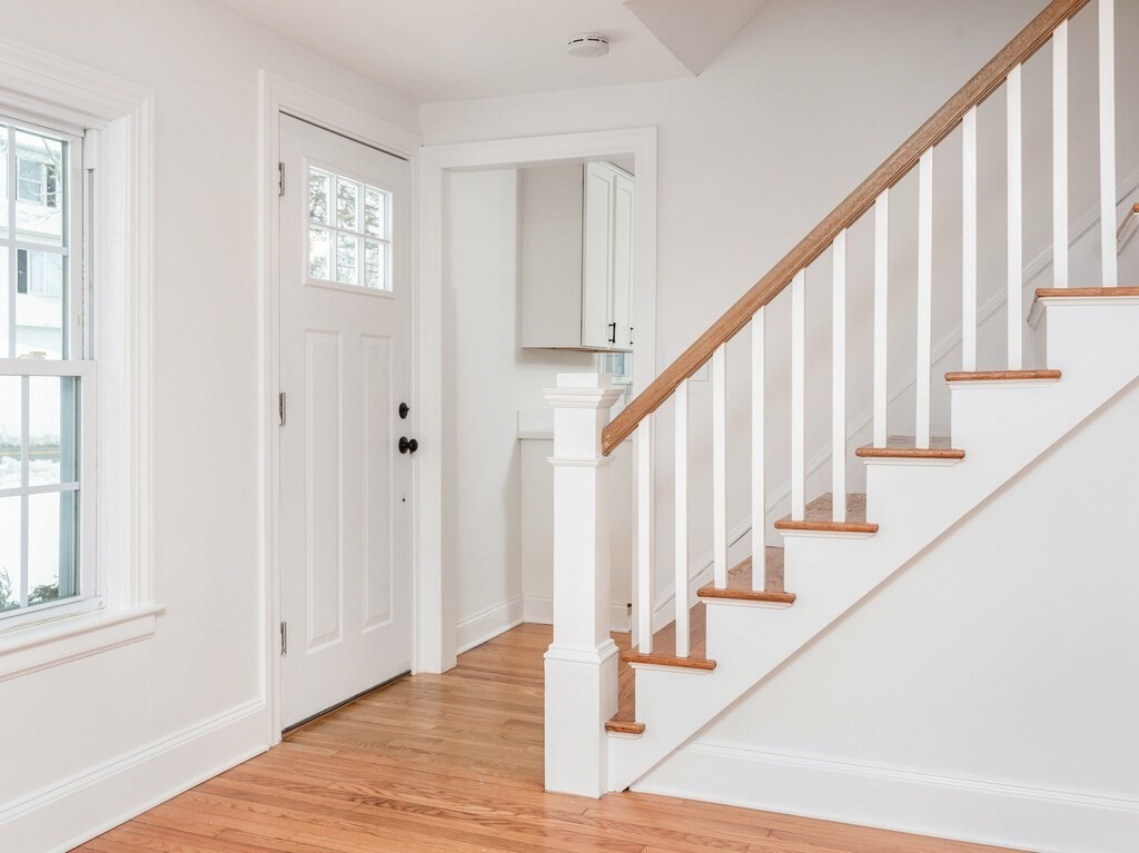 63 Upland Street Worcester, MA 01607 - Photo 16 of 36 a view of staircase with lots of frames on wall and wooden floor