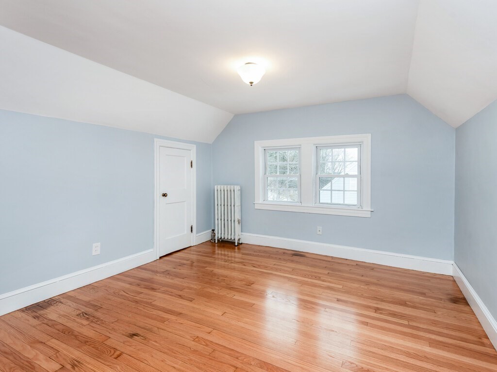 63 Upland Street Worcester, MA 01607 - Photo 20 of 36 an empty room with wooden floor and windows