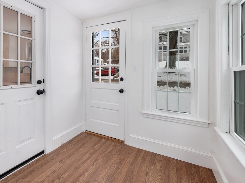 63 Upland Street Worcester, MA 01607 - Photo 29 of 36 an empty room with wooden floor and windows