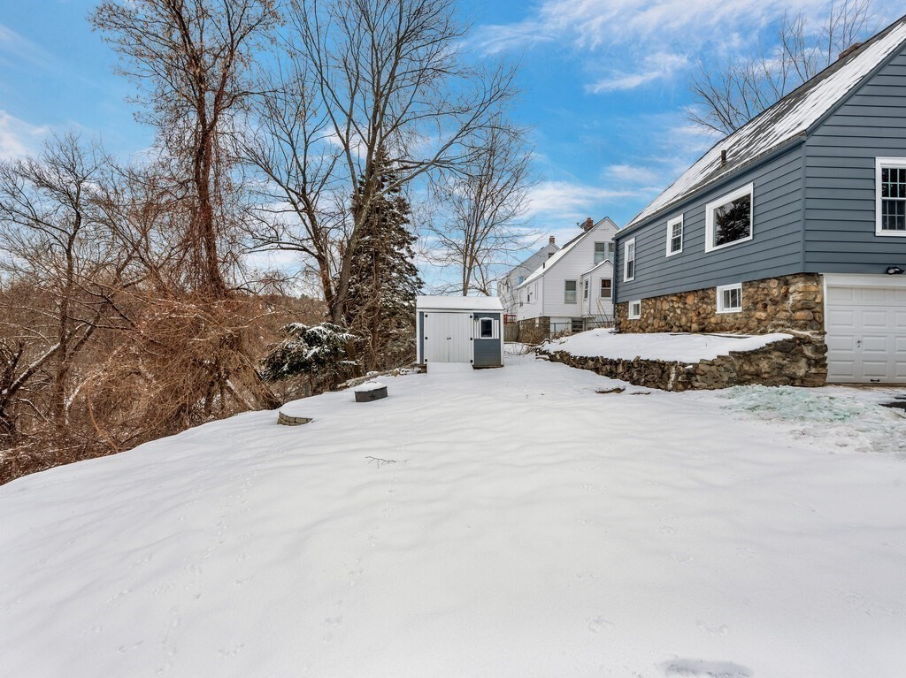 63 Upland Street Worcester, MA 01607 - Photo 32 of 36 a view of a house with a snow in yard