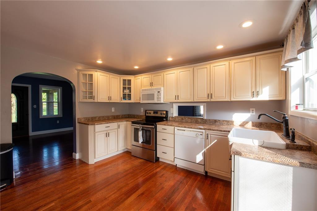 623 Marco Road Apollo, PA 15613 - Photo 11 of 42 a kitchen with granite countertop wooden floors stainless steel appliances and sink
