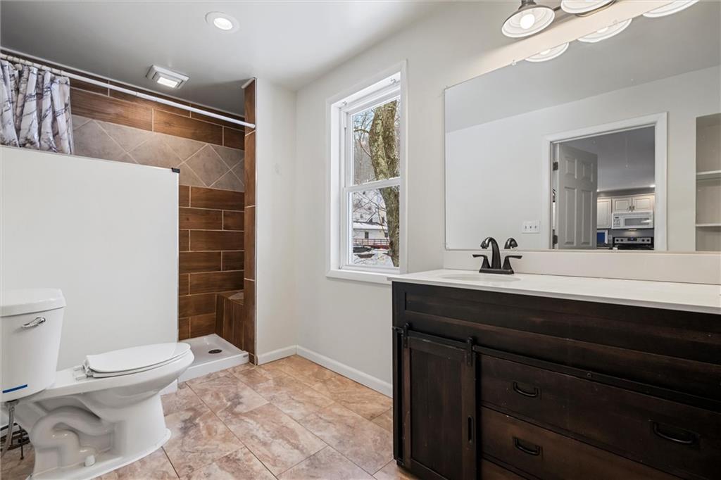 623 Marco Road Apollo, PA 15613 - Photo 14 of 36 a bathroom with a sink a toilet a shower and a mirror