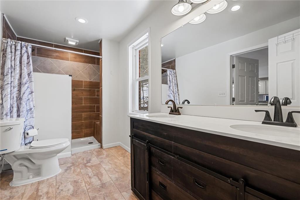 623 Marco Road Apollo, PA 15613 - Photo 16 of 36 a bathroom with a double vanity sink mirror and toilet