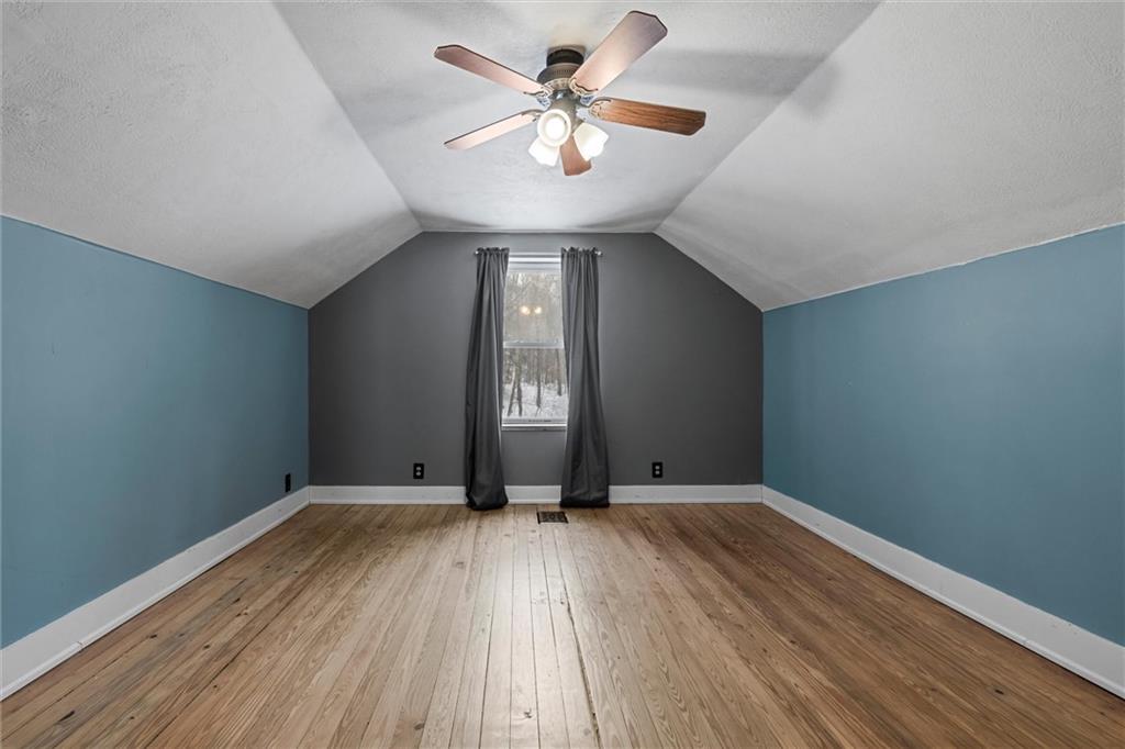 623 Marco Road Apollo, PA 15613 - Photo 19 of 36 a view of an empty room with window and wooden floor