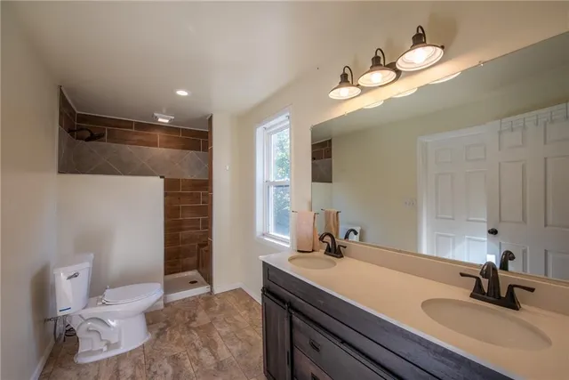 a bathroom with a sink a light fixture and a toilet