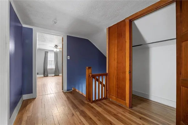 a view of hallway with wooden floor