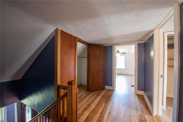 a view of hallway with stairs and wooden floor