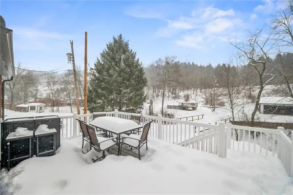 a view of a terrace with furniture and city view