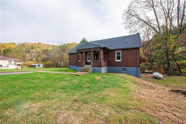a front view of a house with a yard