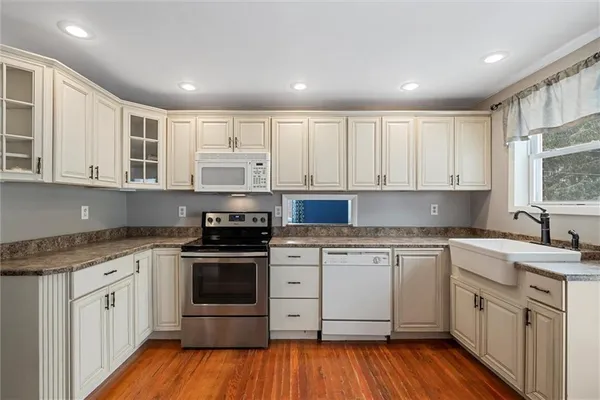 a kitchen with a sink stove and cabinets
