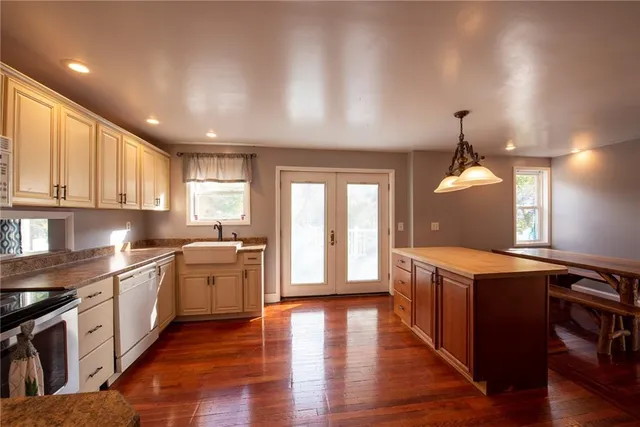 a kitchen with a stove sink and cabinets