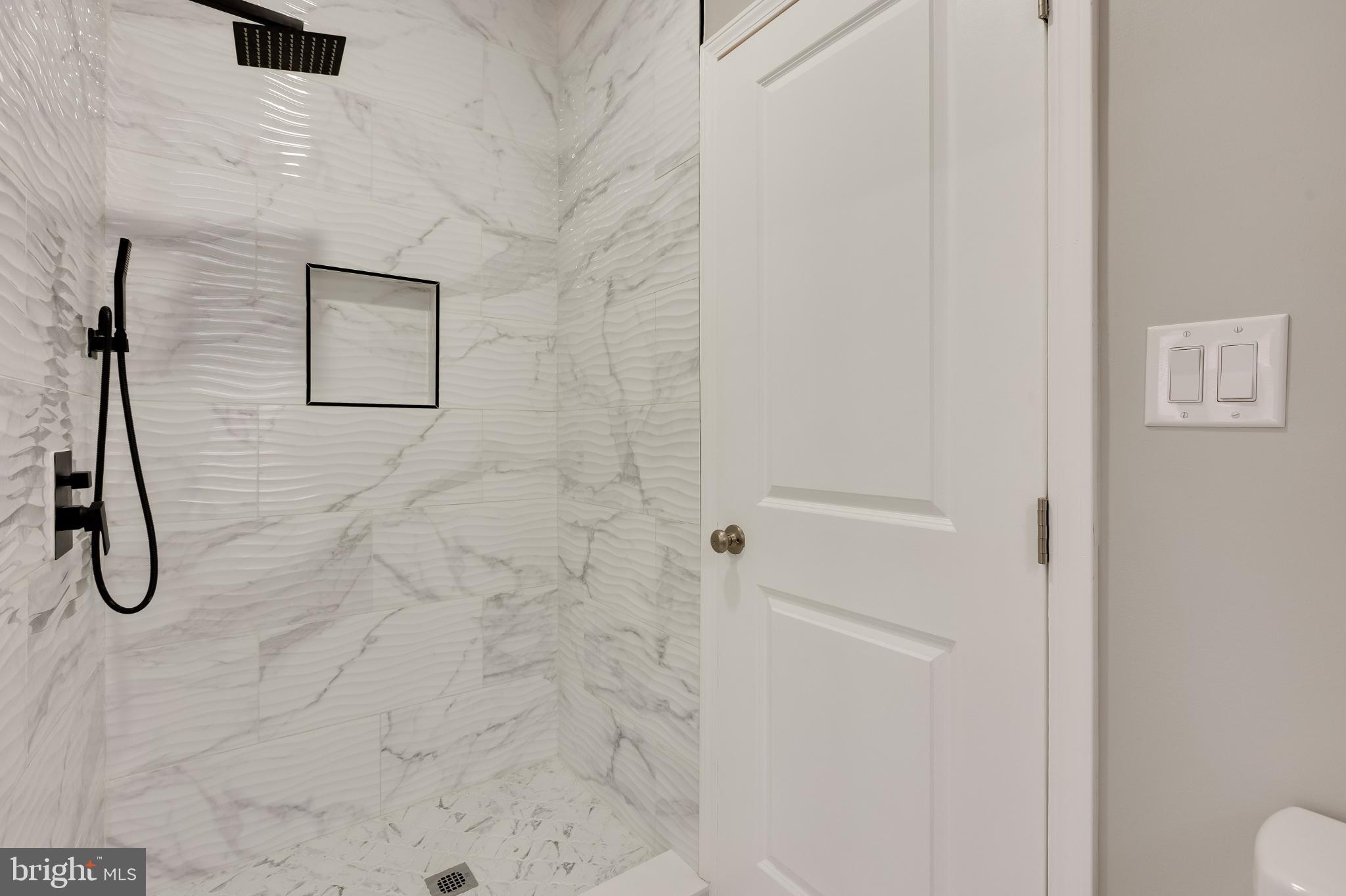 5239 Arch Street Philadelphia, PA 19139 - Photo 23 of 36 Sleek marble shower with modern fixtures.