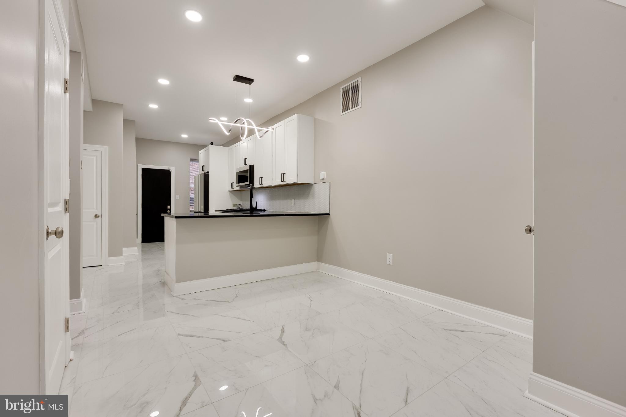 5239 Arch Street Philadelphia, PA 19139 - Photo 3 of 36 Sleek modern kitchen with elegant finishes.