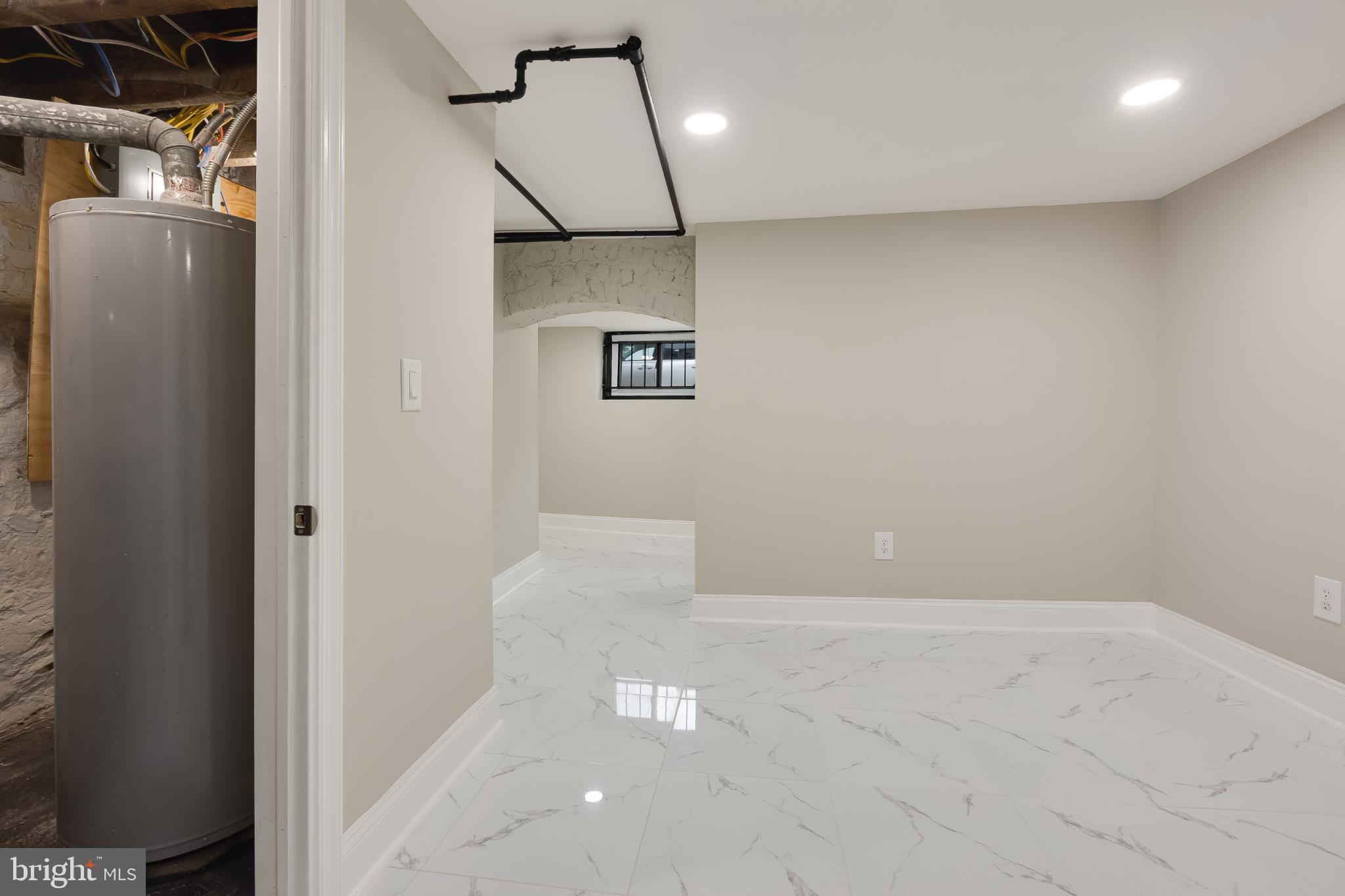 5239 Arch Street Philadelphia, PA 19139 - Photo 31 of 36 Modern basement with sleek marble flooring.