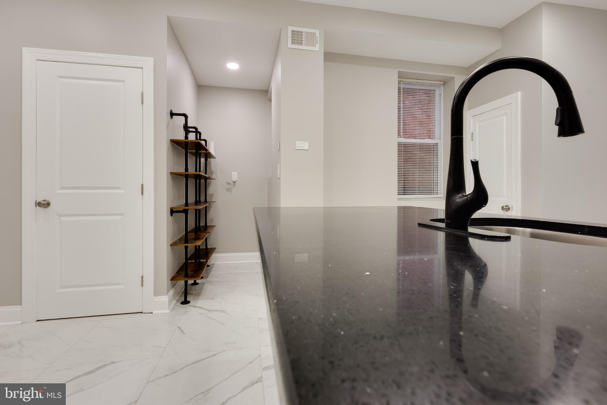 5239 Arch Street Philadelphia, PA 19139 - Photo 5 of 36 Sleek modern kitchen with elegant finishes.