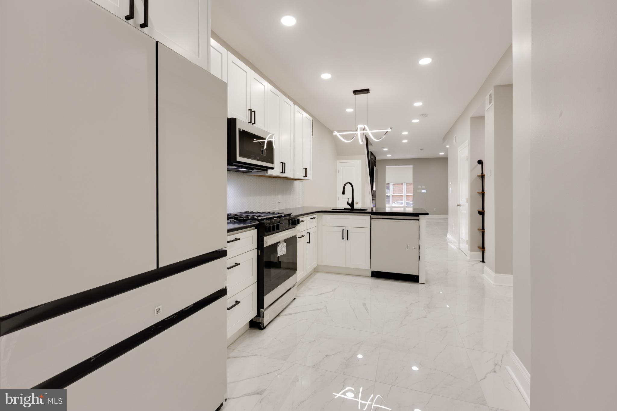 5239 Arch Street Philadelphia, PA 19139 - Photo 6 of 36 Sleek modern kitchen with elegant finishes.