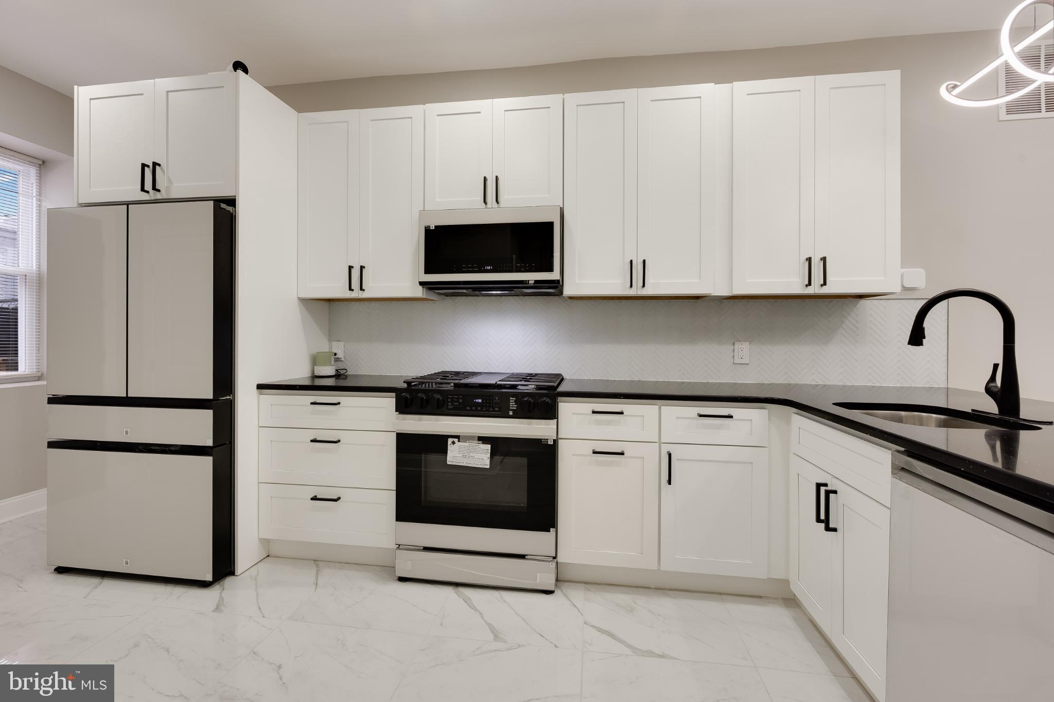 5239 Arch Street Philadelphia, PA 19139 - Photo 7 of 36 Sleek modern kitchen with elegant finishes.