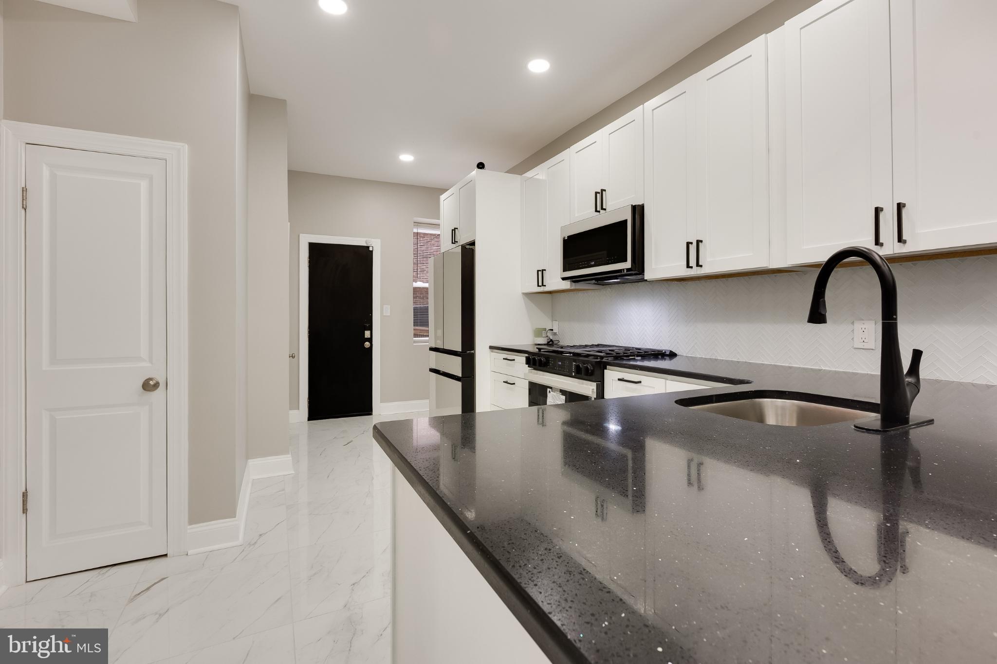 5239 Arch Street Philadelphia, PA 19139 - Photo 8 of 36 Sleek modern kitchen with elegant finishes.