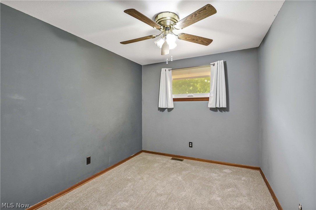 301 Crosse Road Amherst, OH 44001 - Photo 31 of 49 Room featuring neutral-toned carpeting, grey wall paint, and a white ceiling