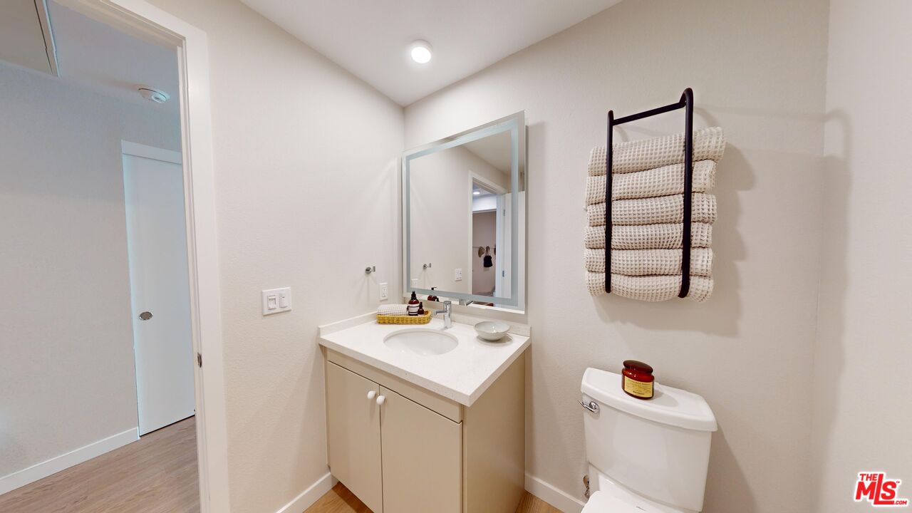 200 Mesnager Street, Unit 618 Los Angeles, CA 90012 - Photo 7 of 24 a bathroom with a sink toilet vanity and tub
