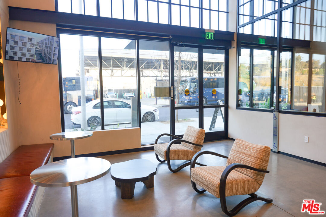 200 Mesnager Street, Unit 618 Los Angeles, CA 90012 - Photo 9 of 24 a living room with furniture and a large window