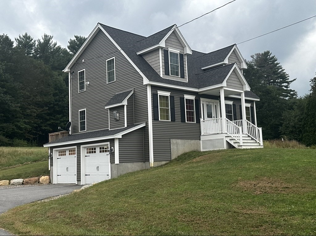176 Oakham Road Barre, MA 01005 - Photo 1 of 36 a front view of a house with a yard and garage