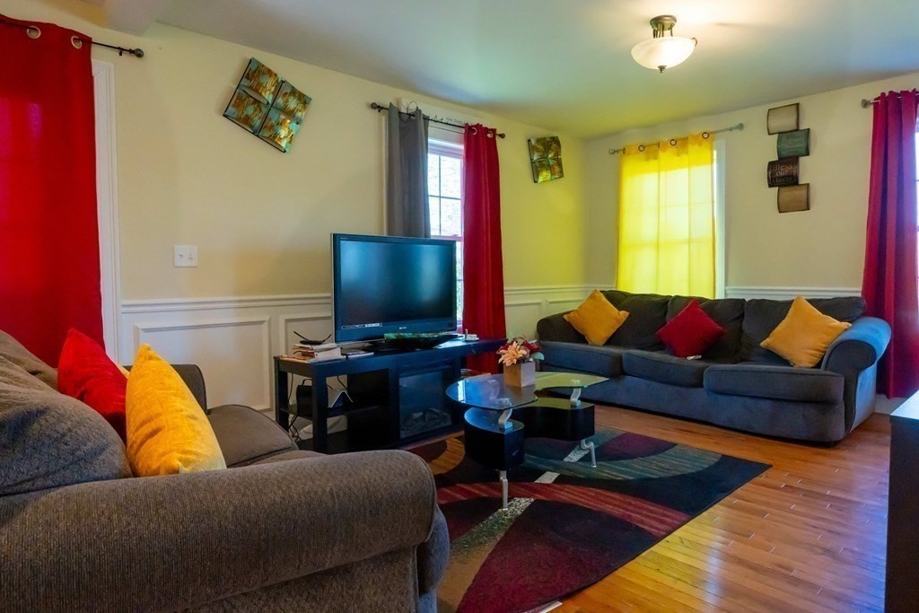176 Oakham Road Barre, MA 01005 - Photo 16 of 36 a living room with furniture and a flat screen tv