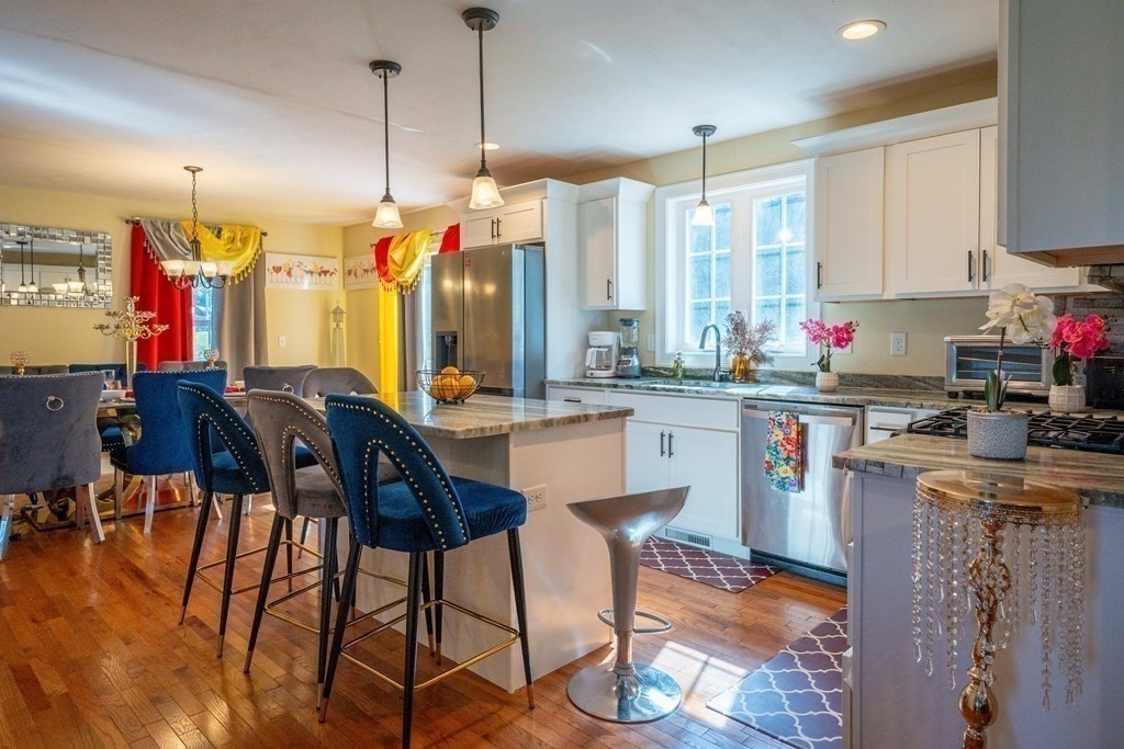 176 Oakham Road Barre, MA 01005 - Photo 20 of 36 a kitchen with stainless steel appliances kitchen island granite countertop a stove a sink and a refrigerator