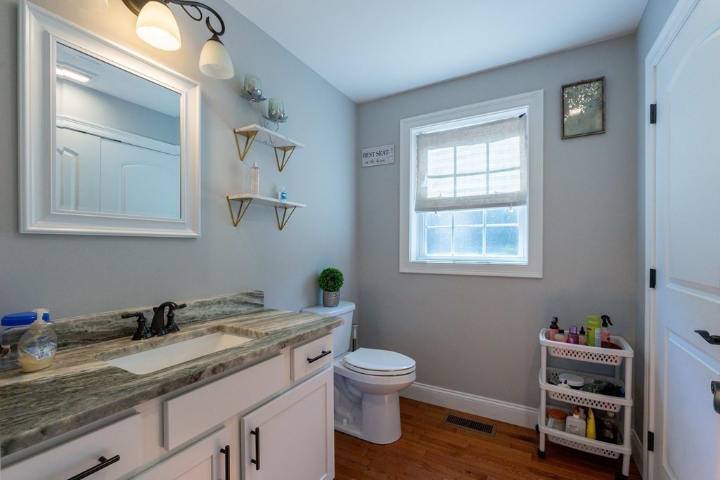 176 Oakham Road Barre, MA 01005 - Photo 24 of 36 a bathroom with a granite countertop toilet sink and mirror