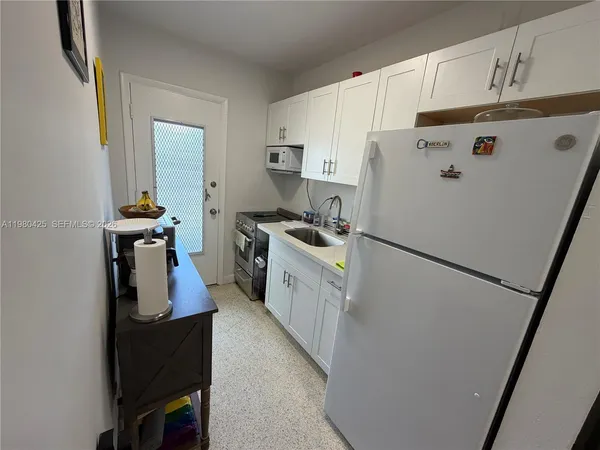a white refrigerator freezer sitting inside of a kitchen