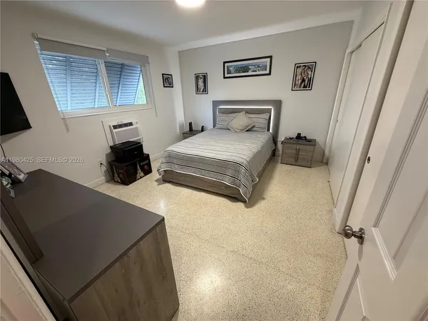 a bedroom with a bed and a dresser