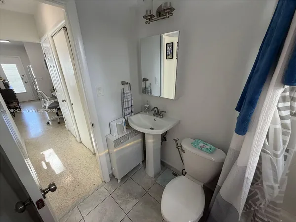 a bathroom with a sink toilet and mirror