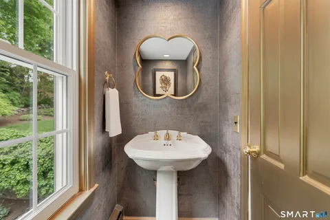 a bathroom with a sink a mirror and a window