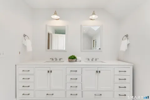 a bathroom with a sink vanity and mirror