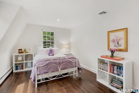 a bedroom with a bed and a book shelf