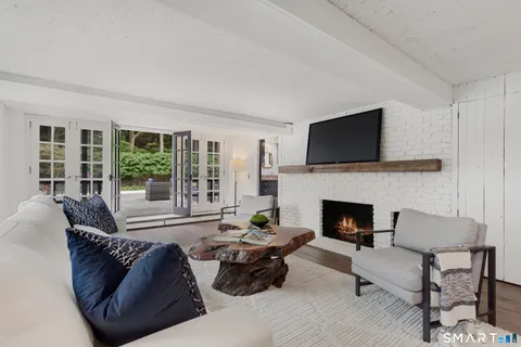 a living room with furniture fireplace and a flat screen tv