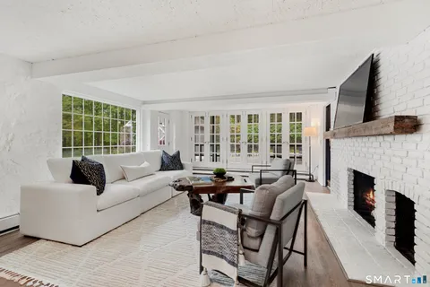 a living room with fireplace furniture and a fireplace