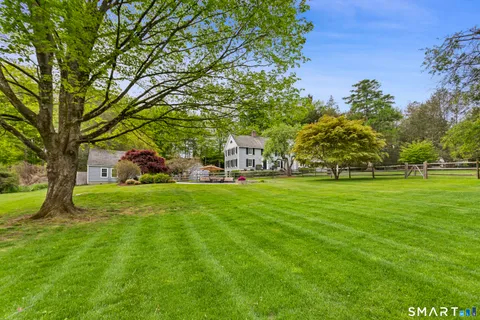 a view of yard with swimming pool and green space
