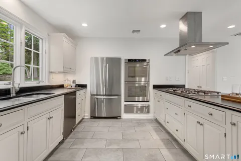 a kitchen with a refrigerator and a sink