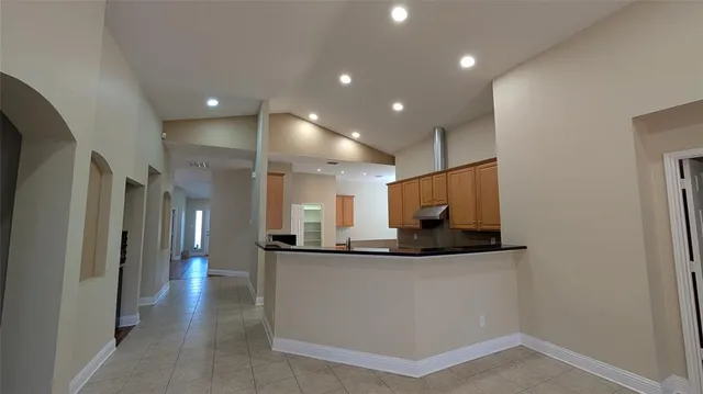 an empty room with windows and fireplace