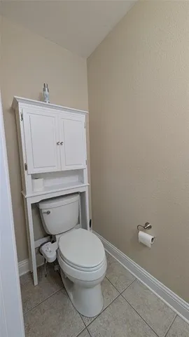 a white toilet sitting next to a bathroom sink