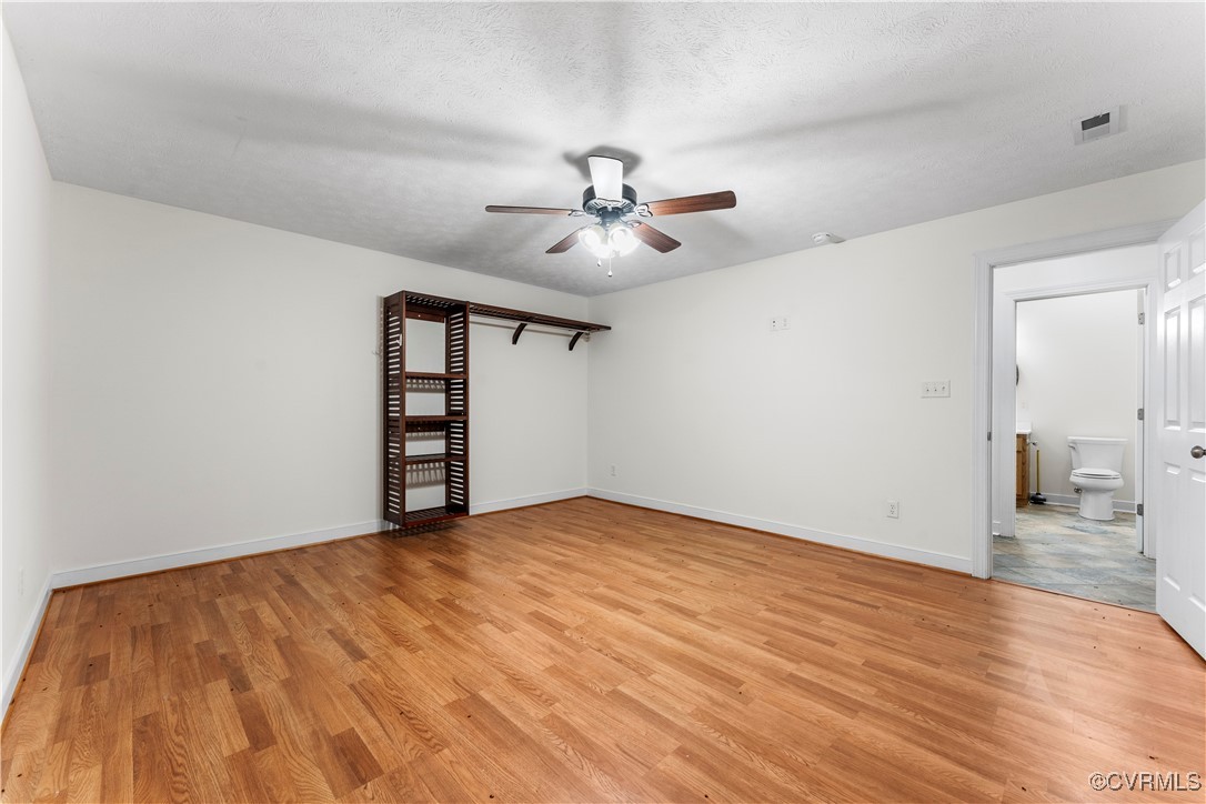 12102 Colemans Lake Road Ford, VA 23850 - Photo 41 of 50 a view of empty room with wooden floor and ceiling fan