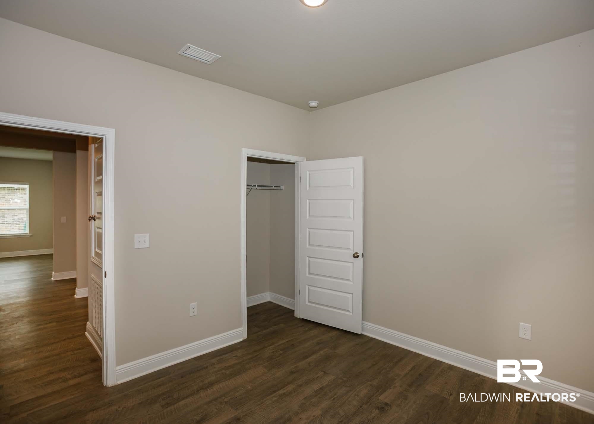 1436 Kairos Loop Foley, AL 36535 - Photo 33 of 52 Unfurnished bedroom featuring dark wood finished floors and a closet