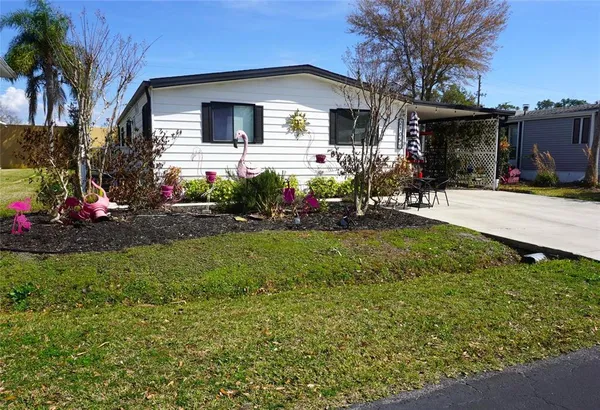 a front view of house with yard and outdoor seating