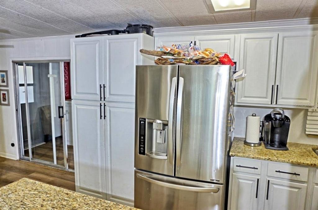 21052 Little Magens Loop Lutz, FL 33558 - Photo 17 of 46 a kitchen with stainless steel appliances granite countertop a refrigerator and a sink