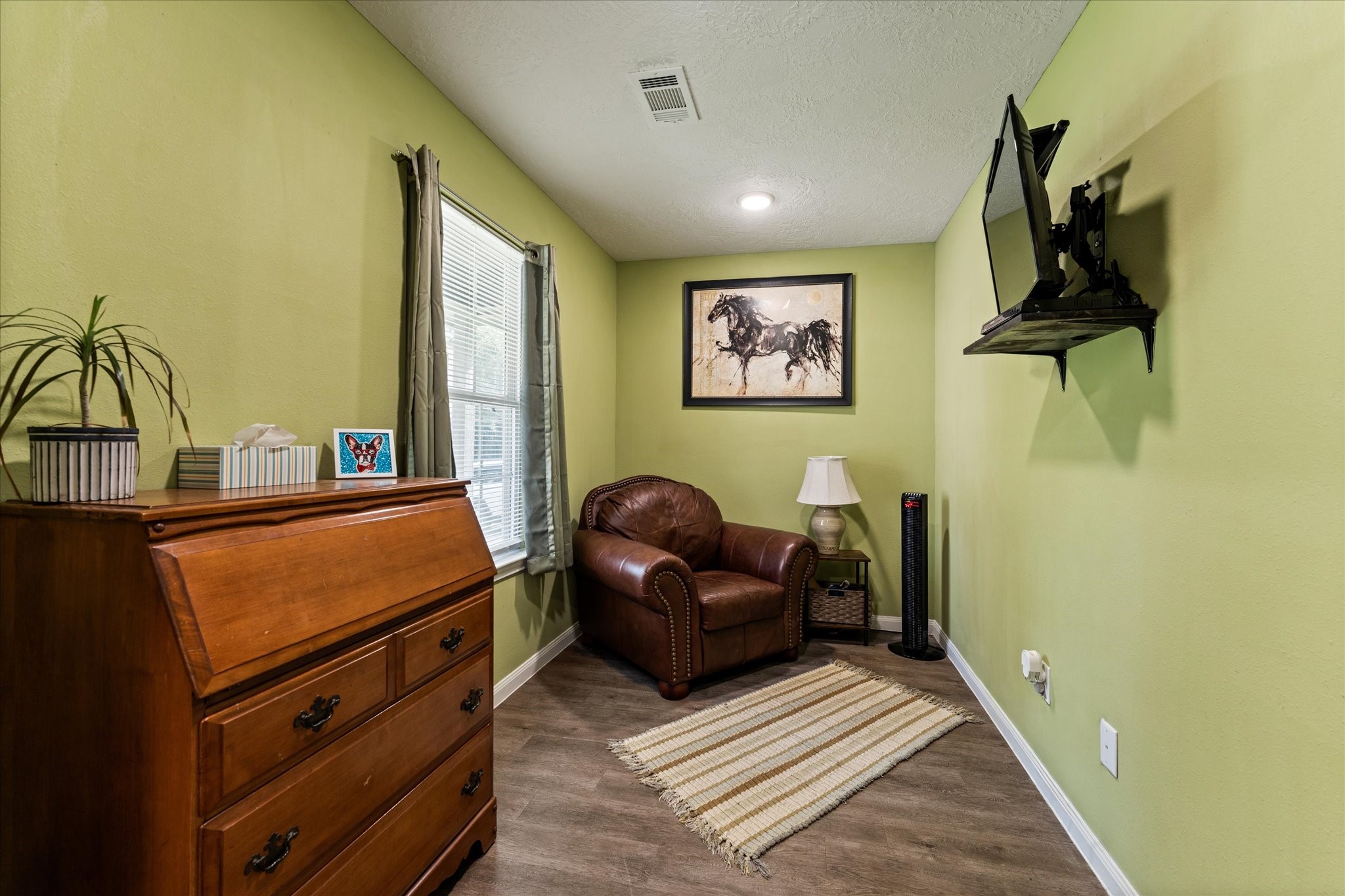 3998 Frontier Road Willis, TX 77378 - Photo 7 of 33 a bedroom with a bed and a dresser