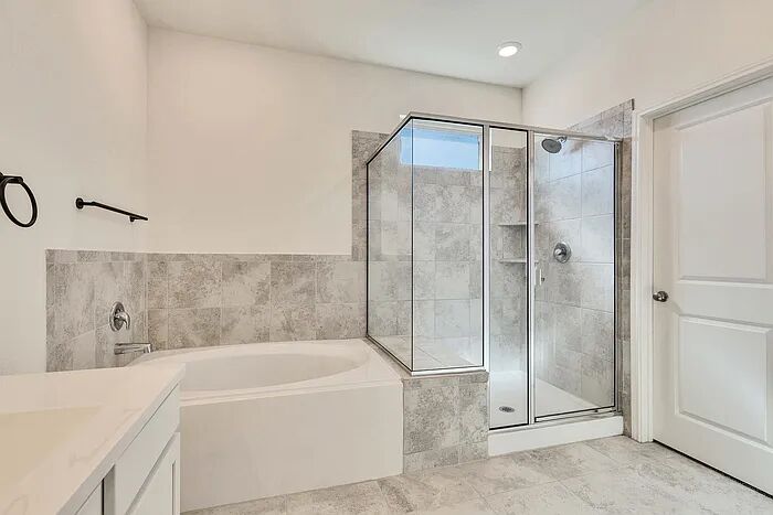 10403 Bramble Berry Drive Austin, TX 78748 - Photo 11 of 21 a bathroom with a bathtub and a shower