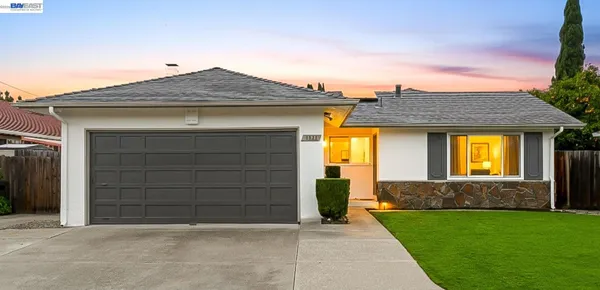 a front view of a house with a yard and garage