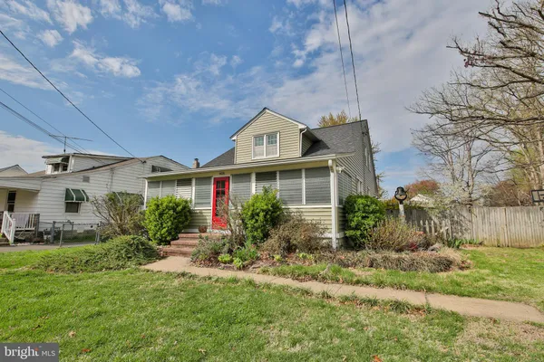 a front view of house with yard and trees around